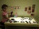 photo of girl working on art project at a light table at the Dixon Millennium Child Care and Development Center