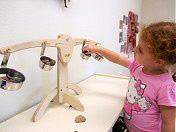 photo of little girl with play kitchen at Dixon Millennium Child Care and Development Center