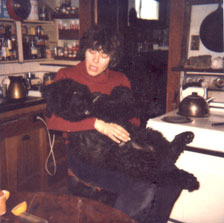 photo of Lynn holding Keya in her lap in our kitchen.